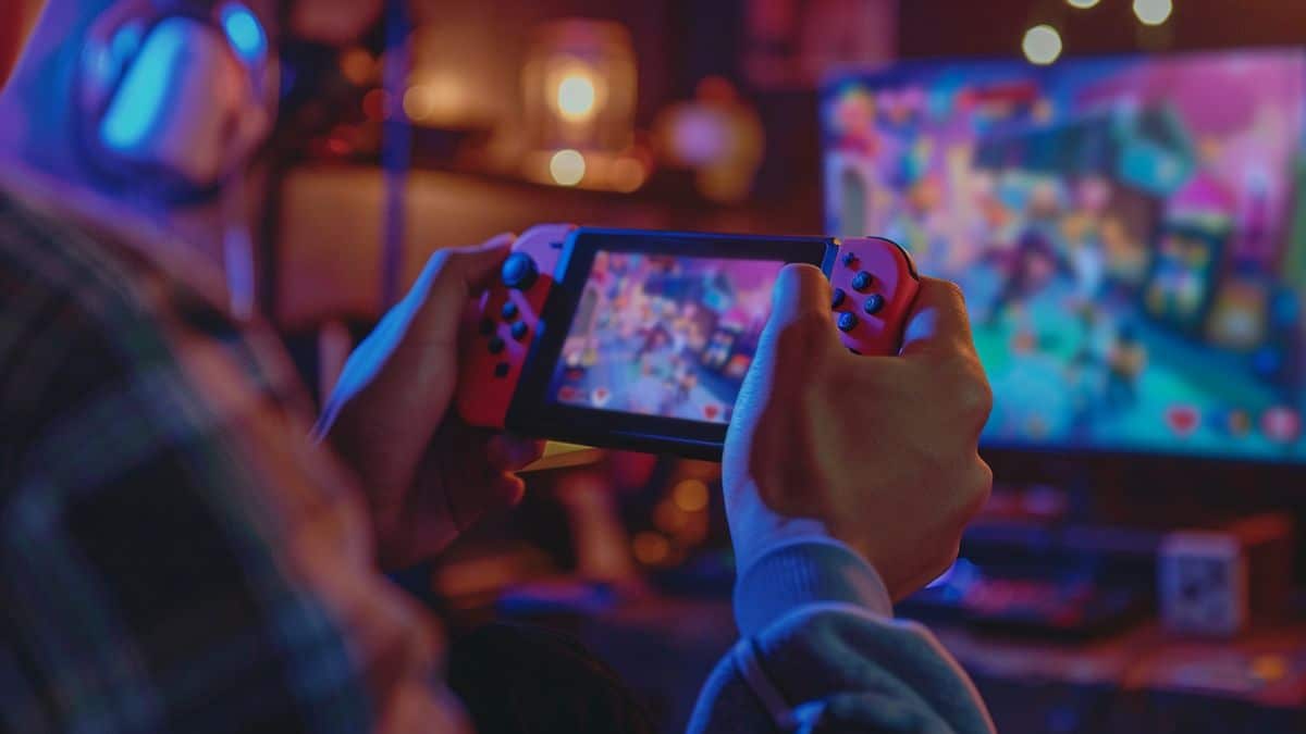 Closeup of a player sharing gameplay on social media with Nintendo Switch.