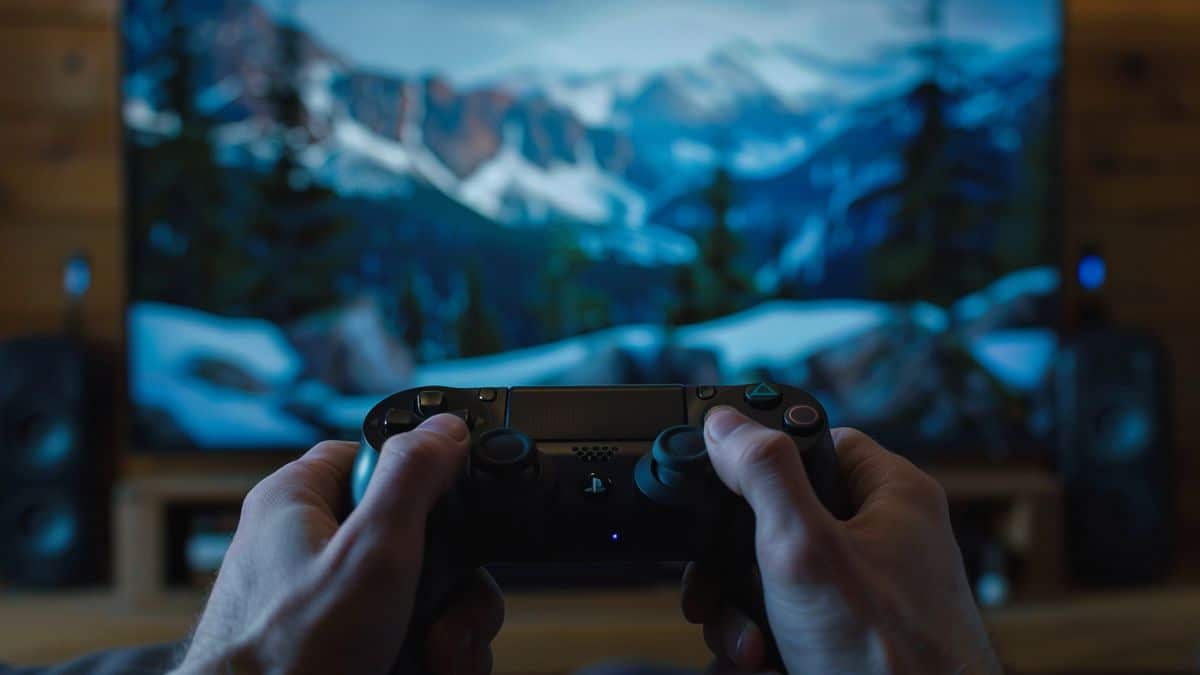 Closeup of hands playing on a PScontroller in front of Bravia TV.